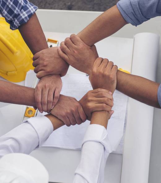 Close up engineer men hands diversity multiethnic partners team together. Group of multiracial people Engineer Manager Foreman Teamwork meeting join hands. Top view office table team join partnership